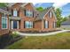 Beautiful brick home with manicured lawn and lush landscaping at 1213 Blue Springs Dr, Loganville, GA 30052