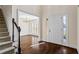 Elegant foyer with hardwood floors, staircase, and view into dining room at 1213 Blue Springs Dr, Loganville, GA 30052