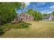Beautiful brick home with mature trees, a manicured lawn, and a classic design at 1213 Blue Springs Dr, Loganville, GA 30052