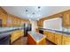Functional kitchen with a center island, wood cabinets, granite countertops, and stainless appliances at 1213 Blue Springs Dr, Loganville, GA 30052