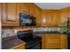 Close up of the kitchen with granite countertops, stainless steel appliances, and hardwood floors at 1213 Blue Springs Dr, Loganville, GA 30052