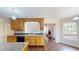 Open kitchen featuring wood cabinets, stainless steel appliances, granite countertops and hardwood floors at 1213 Blue Springs Dr, Loganville, GA 30052