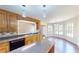 Charming kitchen features wooden cabinetry, stainless steel appliances, and a breakfast nook bathed in natural light at 1213 Blue Springs Dr, Loganville, GA 30052