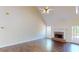 Inviting living room with hardwood floors, a cozy fireplace, and a soaring vaulted ceiling at 1213 Blue Springs Dr, Loganville, GA 30052