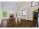 Spacious living room with hardwood floors, fireplace, and ample natural light at 1213 Blue Springs Dr, Loganville, GA 30052