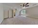 Neutral carpeted bedroom features a window, white walls, and an ensuite bathroom at 1704 Yarborough Dr, Peachtree City, GA 30269