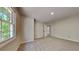 Carpeted bedroom with an open door to the bathroom and an exterior window at 1704 Yarborough Dr, Peachtree City, GA 30269