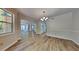 Bright dining area featuring wood-look flooring, modern lighting and seamless flow into other living spaces at 1704 Yarborough Dr, Peachtree City, GA 30269