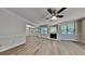 Spacious living room showcasing wood-look floors, a modern fireplace, and seamless transition into the dining area at 1704 Yarborough Dr, Peachtree City, GA 30269