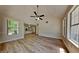 Open-concept living room with hardwood flooring and abundant natural light from large windows at 1704 Yarborough Dr, Peachtree City, GA 30269