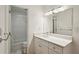 White bathroom showcasing a modern vanity, decorative lighting, and updated shower and tub at 23310 Plantation Ne Dr, Atlanta, GA 30324