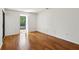 Bright, sunlit bedroom with hardwood floors and a large window offering natural light at 23310 Plantation Ne Dr, Atlanta, GA 30324