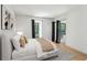 Bright bedroom with a comfy bed, modern decor, and sliding door access to the outside at 23310 Plantation Ne Dr, Atlanta, GA 30324