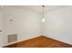A dining room features hardwood floors and a modern pendant light at 23310 Plantation Ne Dr, Atlanta, GA 30324