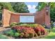Elegant brick entrance sign for The Plantation at Lenox, surrounded by colorful landscaping and greenery at 23310 Plantation Ne Dr, Atlanta, GA 30324