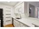 Bright kitchen features white cabinets, stainless steel sink, subway tile backsplash, and built-in shelving at 23310 Plantation Ne Dr, Atlanta, GA 30324