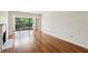 Hardwood floors, fireplace, and balcony with view in a naturally lit living room at 23310 Plantation Ne Dr, Atlanta, GA 30324