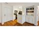 Open-concept living area with hardwood floors flows into a kitchen, accented with built-in shelving at 23310 Plantation Ne Dr, Atlanta, GA 30324