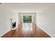 Hardwood floors, fireplace, and balcony with view in a naturally lit living room at 23310 Plantation Ne Dr, Atlanta, GA 30324