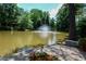 Serene pond with a decorative fountain, surrounded by flowers and landscaping at 23310 Plantation Ne Dr, Atlanta, GA 30324