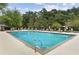 Large, inviting pool surrounded by lush greenery, lounge chairs, and sun umbrellas for relaxation at 23310 Plantation Ne Dr, Atlanta, GA 30324