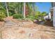 Landscaped backyard with stone retaining wall and stairs leading to upper level at 2566 Garrison Sw, Marietta, GA 30064