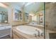 Well lit primary bathroom featuring a soaking tub with tile surround, double sinks, and private water closet at 2566 Garrison Sw, Marietta, GA 30064