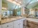 This large bathroom features double sinks with granite countertops, a large mirror, and a separate soaking tub at 2566 Garrison Sw, Marietta, GA 30064