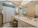 Well-lit bathroom featuring a vanity with a sink, mirror, vanity lighting and a shower with a white shower curtain at 2566 Garrison Sw, Marietta, GA 30064