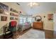 Bedroom featuring a ceiling fan, wall decorations, and wooden floors creating a unique look at 2566 Garrison Sw, Marietta, GA 30064