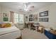 A sunlit bedroom includes a ceiling fan and neutral decor at 2566 Garrison Sw, Marietta, GA 30064