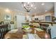 A spacious dining room features an ornate light fixture and barstool seating at the kitchen counter at 2566 Garrison Sw, Marietta, GA 30064