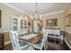 Elegant dining room with dark hardwood floors and a decorative china cabinet, ideal for hosting dinner parties at 2566 Garrison Sw, Marietta, GA 30064