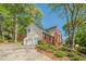 View of a two-story home with brick and siding, a two car garage, and a well-kept lawn at 2566 Garrison Sw, Marietta, GA 30064