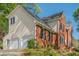 View of a two-story home with brick and siding, a two car garage, and a well-kept lawn at 2566 Garrison Sw, Marietta, GA 30064