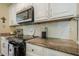 Kitchen counter featuring a stainless steel microwave, coffee maker, and neutral granite countertop at 2566 Garrison Sw, Marietta, GA 30064