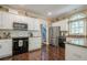Well-equipped kitchen with stainless steel appliances, granite countertops, and dark hardwood flooring at 2566 Garrison Sw, Marietta, GA 30064