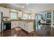 Bright and airy kitchen featuring white cabinets, granite countertops, and dark hardwood floors with an open concept design at 2566 Garrison Sw, Marietta, GA 30064