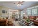 An expansive living room features an open floor plan, brick fireplace and hardwood floors throughout at 2566 Garrison Sw, Marietta, GA 30064