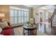 Cozy living area featuring shuttered windows, a comfortable red sofa, and a decorative rug, perfect for relaxation at 2566 Garrison Sw, Marietta, GA 30064
