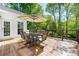 Spacious wood deck with outdoor dining set, umbrella, and views of lush greenery at 4415 Dorset Ln, Suwanee, GA 30024
