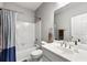 Clean bathroom with a shower-tub combo, white tile, modern vanity, and a well-lit mirror at 4415 Dorset Ln, Suwanee, GA 30024