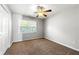 Cozy bedroom with double door closet, neutral paint, and large windows offering plenty of natural light at 4415 Dorset Ln, Suwanee, GA 30024