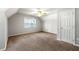 Bright bedroom featuring neutral walls, plush carpet, and a ceiling fan at 4415 Dorset Ln, Suwanee, GA 30024
