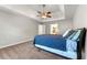 Well-lit bedroom features neutral walls, ceiling fan, and large window offering ample natural light at 4415 Dorset Ln, Suwanee, GA 30024