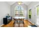Bright dining room with hardwood floors, high ceilings, large arched windows, and stylish decor at 4415 Dorset Ln, Suwanee, GA 30024