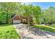 Two-story brick home featuring an attached two-car garage and long driveway at 4415 Dorset Ln, Suwanee, GA 30024
