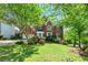 Charming two-story brick home featuring a well-manicured lawn and mature landscaping at 4415 Dorset Ln, Suwanee, GA 30024