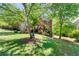 Beautiful brick home with a manicured lawn, flowering shrubs, and mature trees at 4415 Dorset Ln, Suwanee, GA 30024