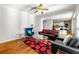 Open-concept living room with hardwood floors, modern furnishings, and an entryway to the kitchen area at 4415 Dorset Ln, Suwanee, GA 30024